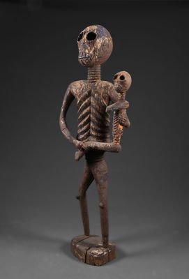 une statue représentant un squelette tenant un bébé dans ses bras