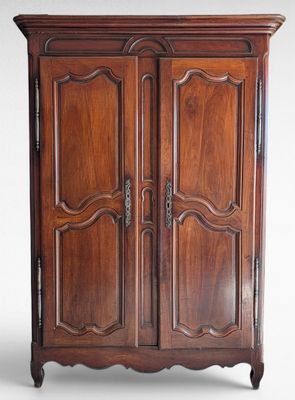 an antique wooden armoire with two doors and two drawers