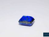 a square blue stone with a small hole in the middle of it