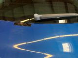 a close up of a car ' s windshield with a sticker on it