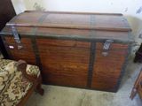 a wooden chest sitting next to a chair in a room