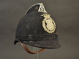 an old black helmet with a gold crest on it