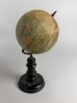 an old globe on a black stand with a white background