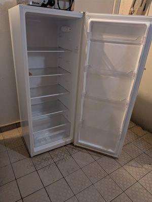 a white refrigerator with its door open in a kitchen