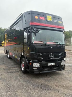 a large black bus that is parked in the parking lot