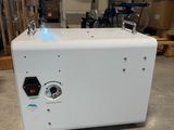 a white machine sitting on top of a table in a warehouse