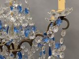 a chandelier with blue and clear crystals hanging from it