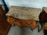 two wooden chests with marble tops in a room