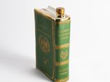 a green flask with a gold lid on a white background
