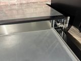 a silver counter top with a silver oven inside of it