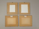 three wooden picture frames hanging on a wall with clippings attached to them