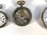 several different types of pocket watches are displayed on a white surface