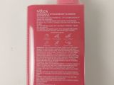 a close up of a bottle of lotion on a white surface
