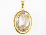 un pendentif plaqué or orné d'une topaze blanche facettée