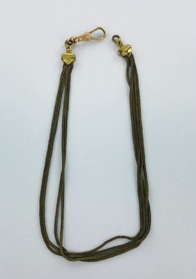 a close up of a necklace on a white surface