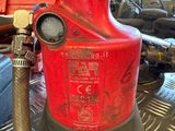 a red fire hydrant sitting on top of a metal table