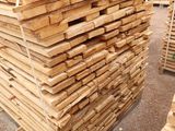 several stacks of wooden planks stacked on top of each other