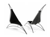 two black and white lounge chairs with a black cover on them