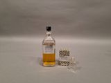 a small bottle of alcohol next to a small box