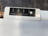 a close up of a white washing machine with a sign on it
