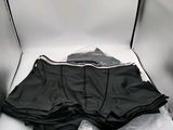 a box with a pair of black underwear in it