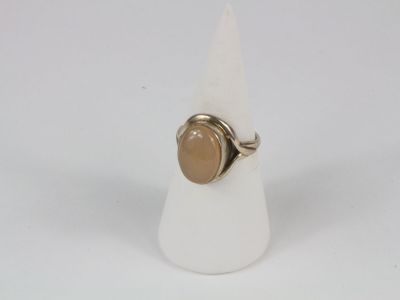 an image of a ring with a brown stone on top of a white cone