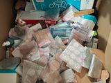 a cardboard box filled with medical supplies and a teddy bear