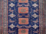 a blue and red rug with a design on it