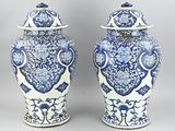 pair of blue and white vases with lids on a gray background