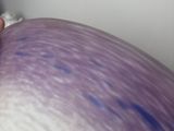 a man that is holding a purple object in his hand