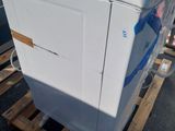 a washing machine on a pallet in the parking lot