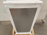 an image of a white refrigerator sitting on top of a pallet