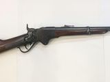 a rifle that is on display on a wall