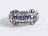 an image of a blue and white diamond ring on a white surface