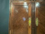 a wooden cabinet with two doors on top of it