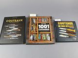 three books on a table with knives in a wooden box