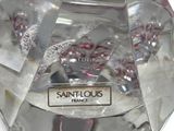 a clear glass object with a red and white design on it