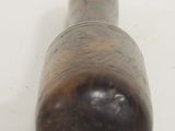 a small wooden object that is on a white surface