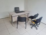 un bureau avec deux chaises et un ordinateur dessus