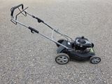 an image of a lawn mower sitting on the ground