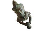 a close up of a statue of a person holding a pipe