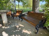 two wooden benches sitting next to each other in a park