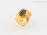 an image of a gold ring with a black stone in the center