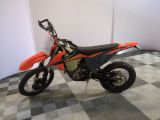 an image of a dirt bike parked on a checkered floor