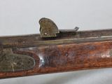 an old gun with a wooden handle on a white background