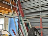 a pile of skis and a pile of luggage in a garage