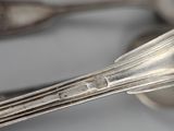 a lot of silver spoons and forks on the table