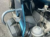 a blue motorcycle parked on the side of the road