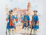 two men in blue uniforms standing next to each other in front of a building