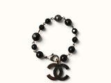 chanel bracelet with black onyx beads and a chanel charm